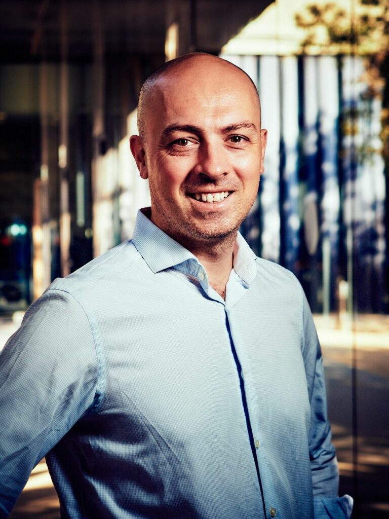 A male portrait with building behind