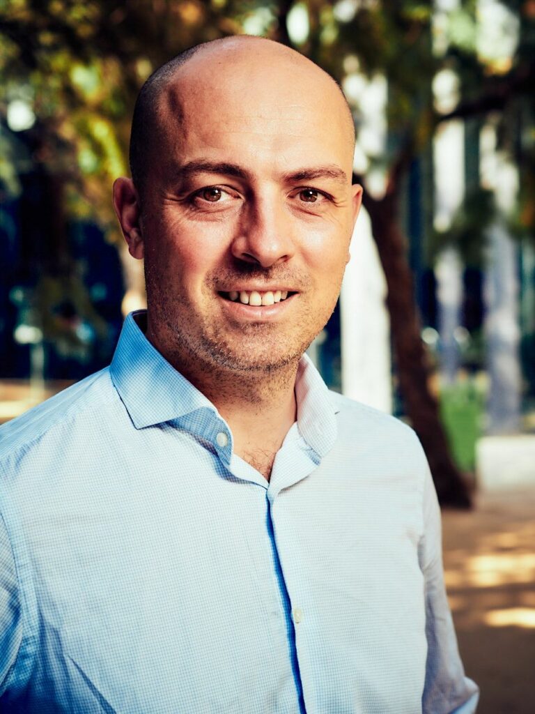 A male portrait with trees behind