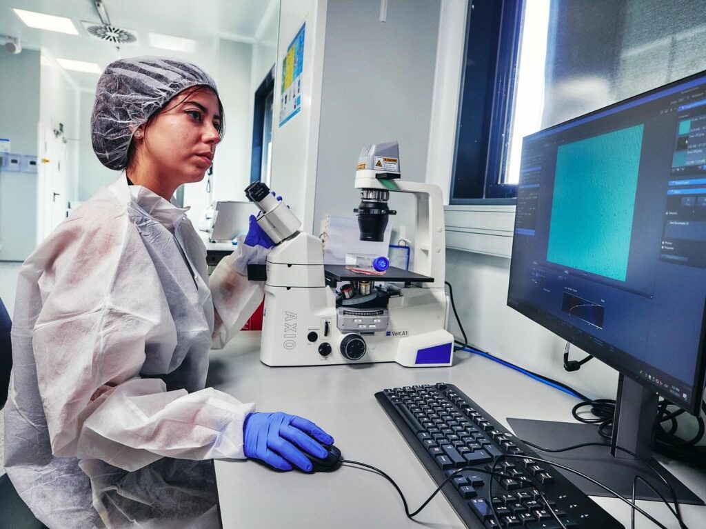 A young woman using a microscope