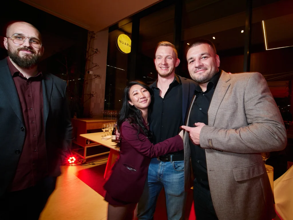 Group of Odys clients and hosts sharing a genuine laugh during the networking event at Nuara restaurant in Barcelona's Port Vell.