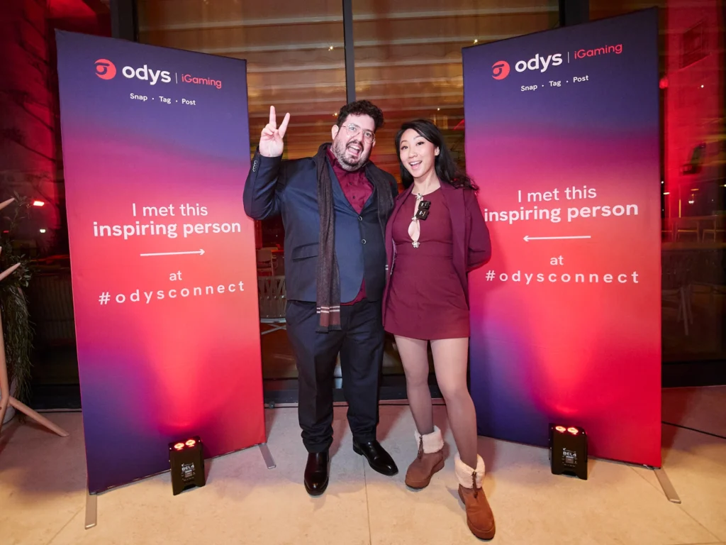 A tech executive looks confidently at the camera during the Odys corporate client evening, with Nuara's sophisticated mood lighting in the background.