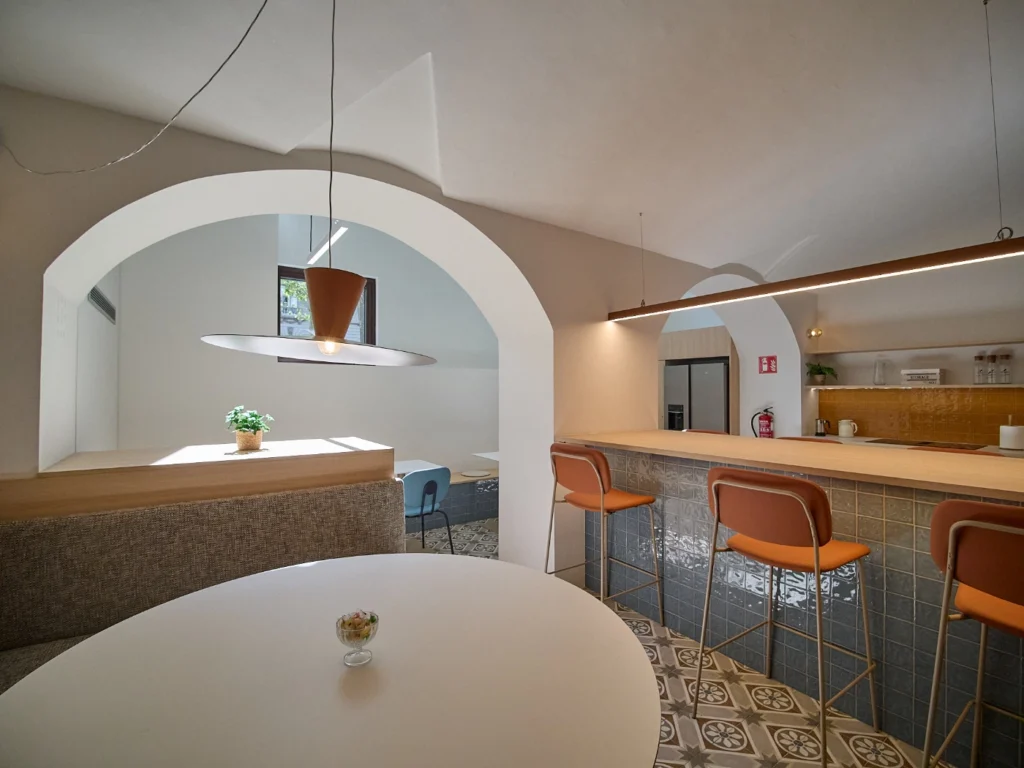 : A communal kitchen area in an upmarket coworking space, designed for social interaction and networking.