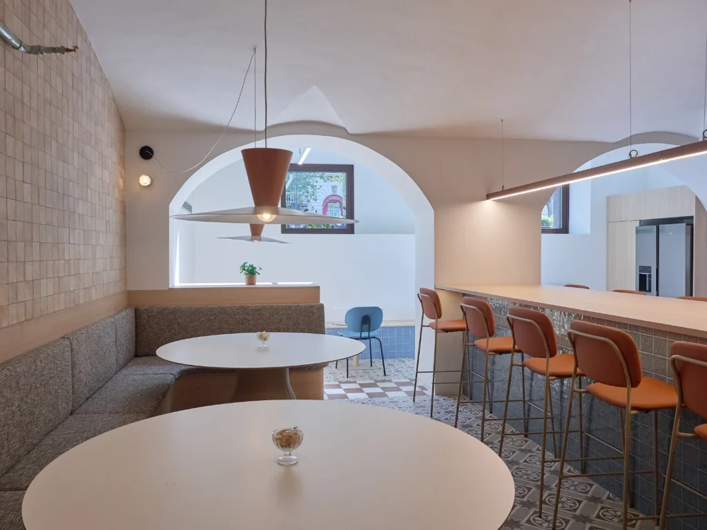A relaxed and stylish lounge area designed for collaboration, featuring modern furniture and a warm, welcoming ambiance.
