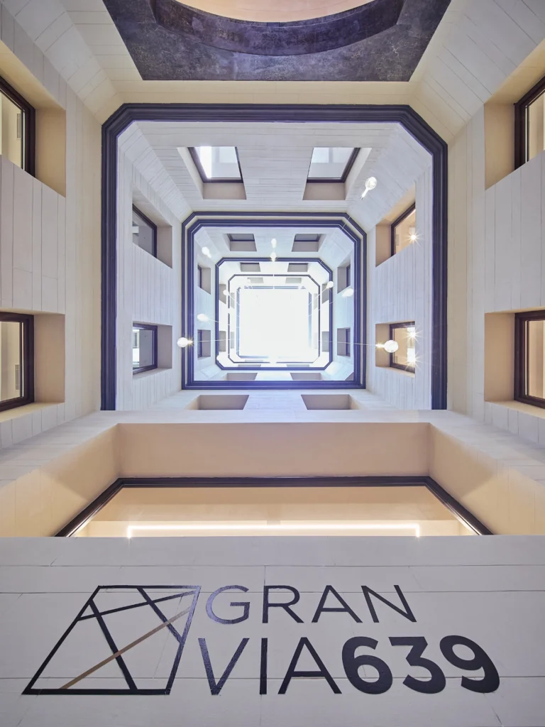 A professional and welcoming reception area in an upscale Barcelona coworking space, featuring modern design and a sophisticated atmosphere.