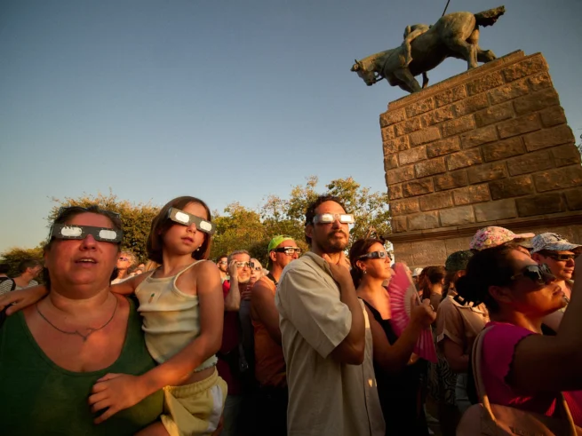 People wearing solar eclipse glasses on Montjuic