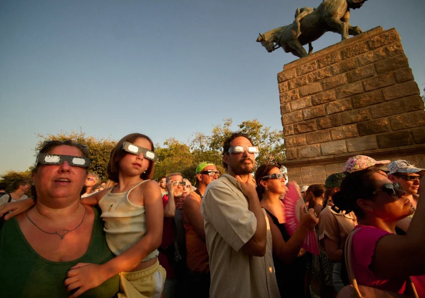 People wearing solar eclipse glasses on Montjuic