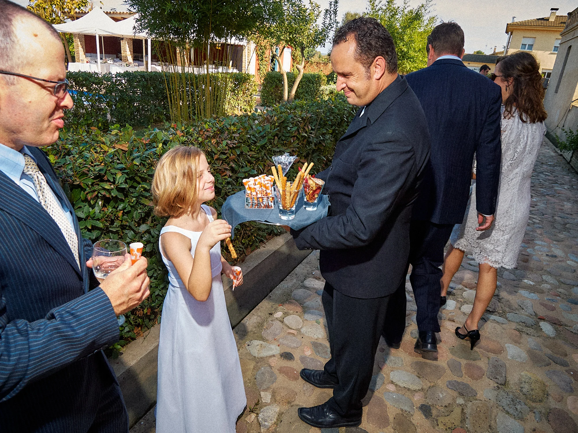 Young wedding guest speaking with an adult during the Can Tallada celebration