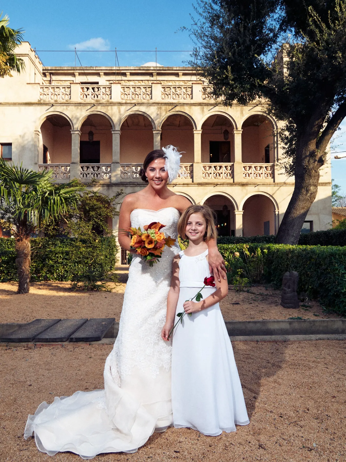 Bride with flower girl in front of the Can Tallada estate