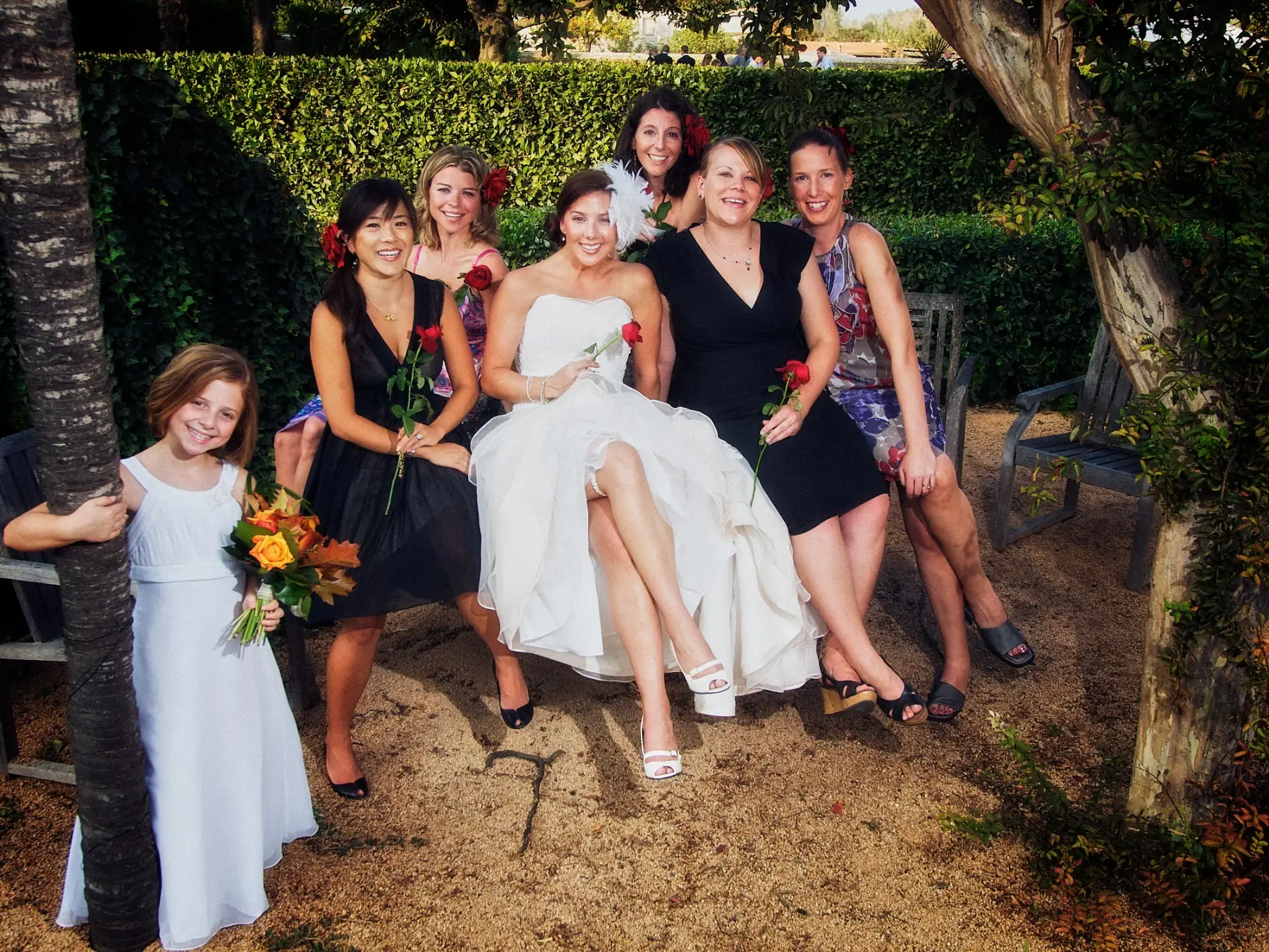 Bride with bridesmaids and flower girl in the Can Tallada gardens