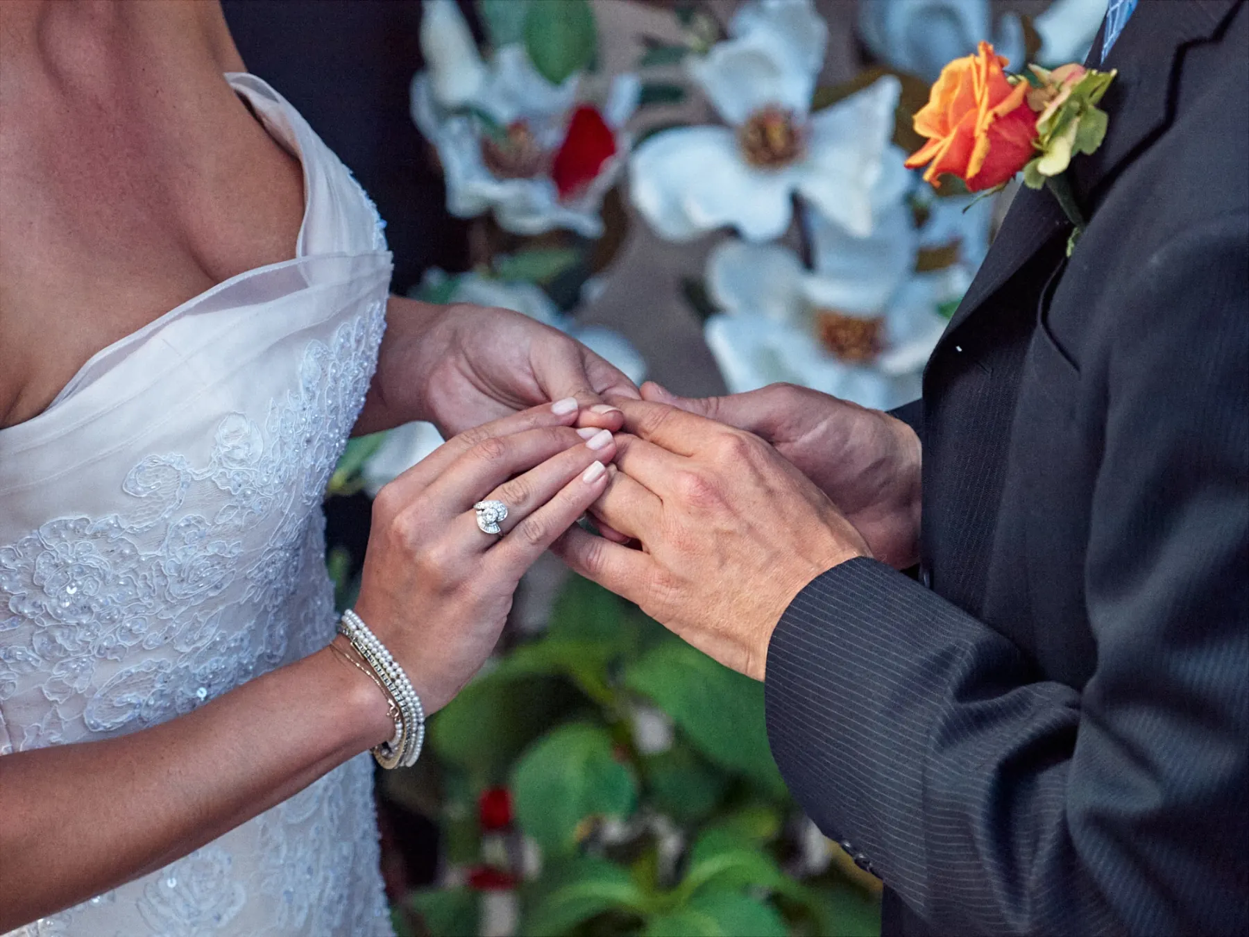 Bride placing a wedding ring on the groom’s hand during the ceremony