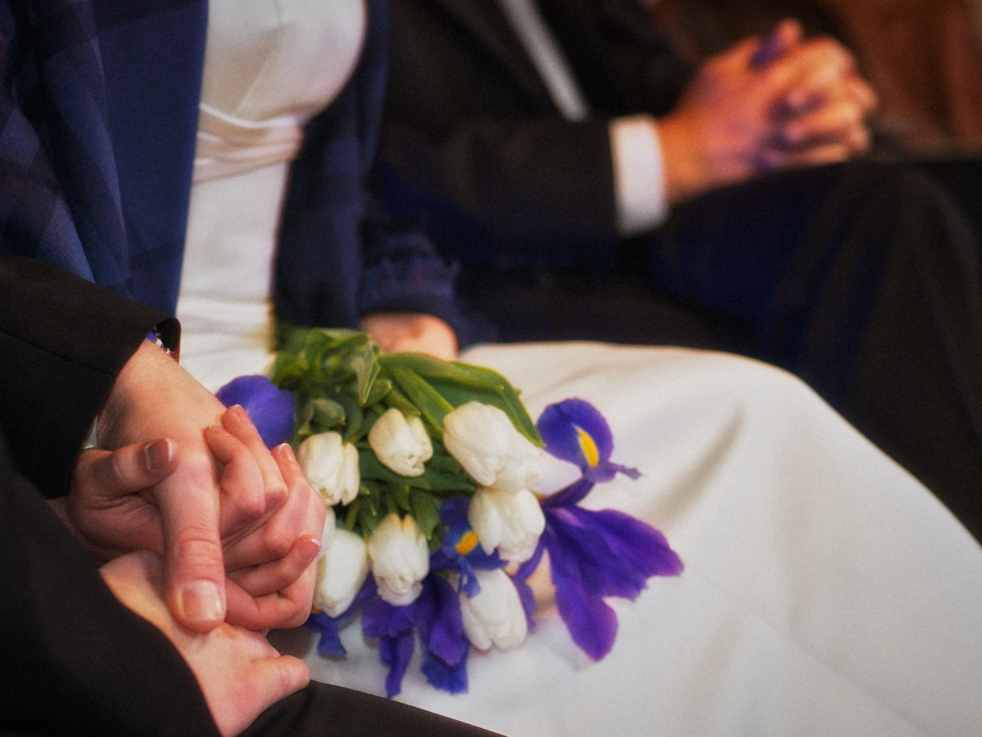Drea & Brian Granada Wedding – Hands and Bouquet Wedding guests holding hands beside Drea’s bouquet during the ceremony