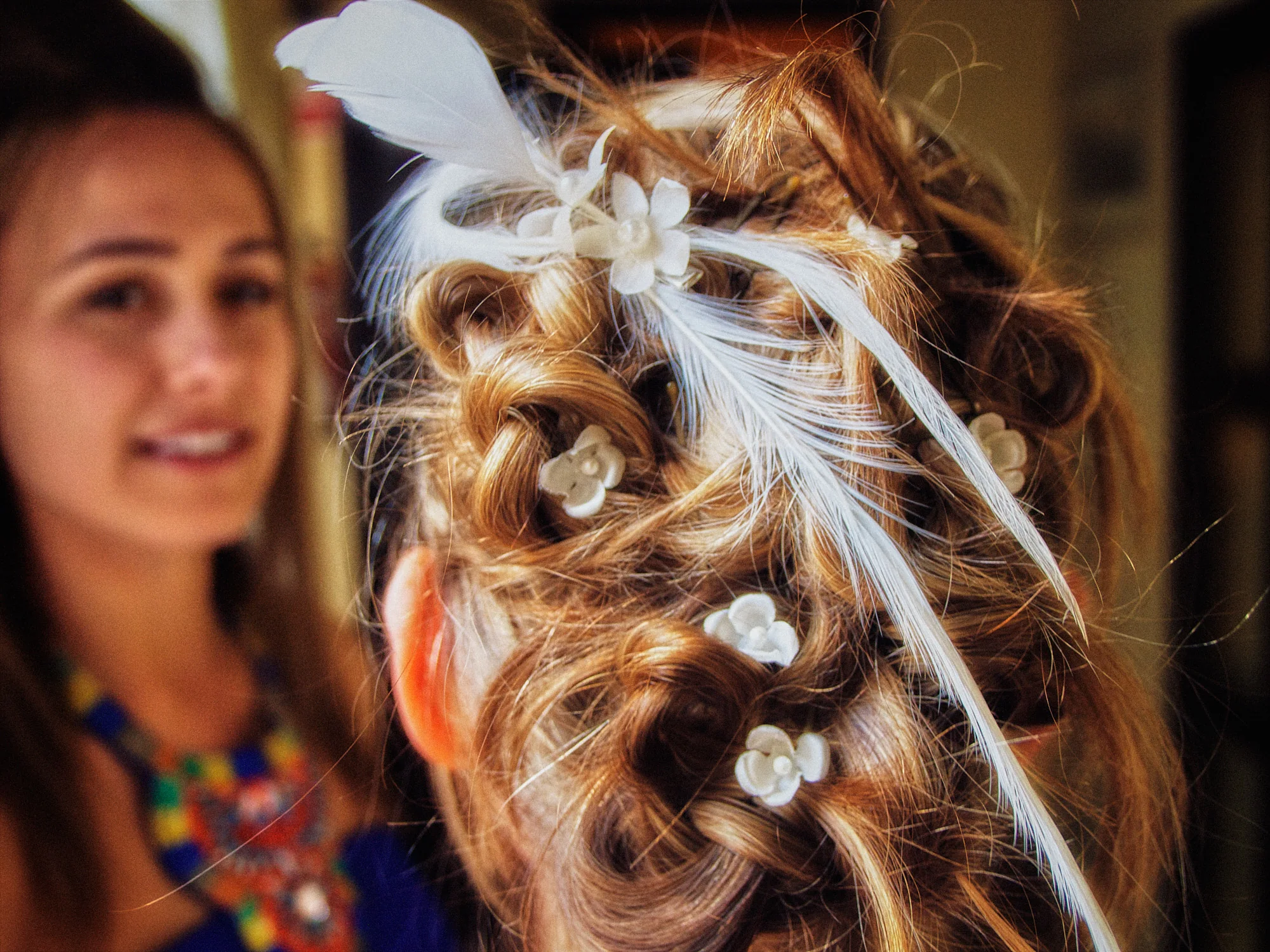 Drea & Brian Granada Wedding – Hair Detail Drea’s bridal hair detail with feather and flower accessories during preparations
