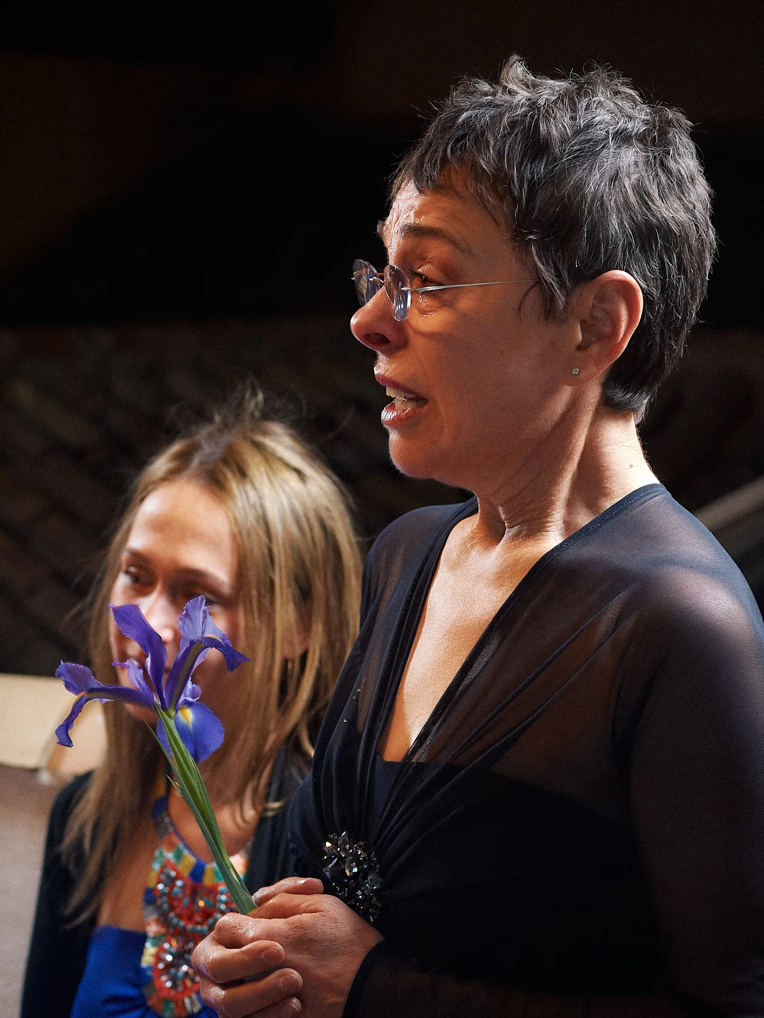 Drea & Brian Granada Wedding – Wedding Guest Portrait A wedding guest holding a purple iris during Drea and Brian’s Granada wedding