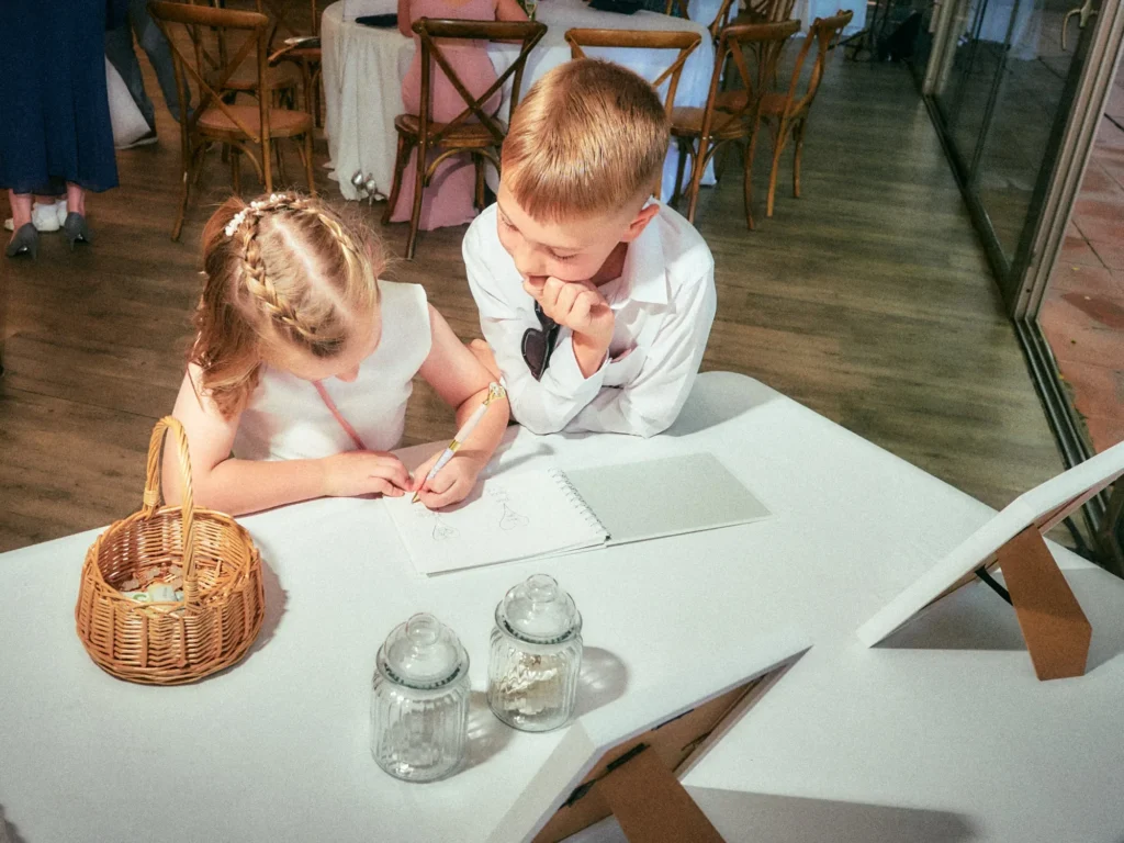 Children drawing together at a table during Jade and Aidhan’s Barcelona wedding