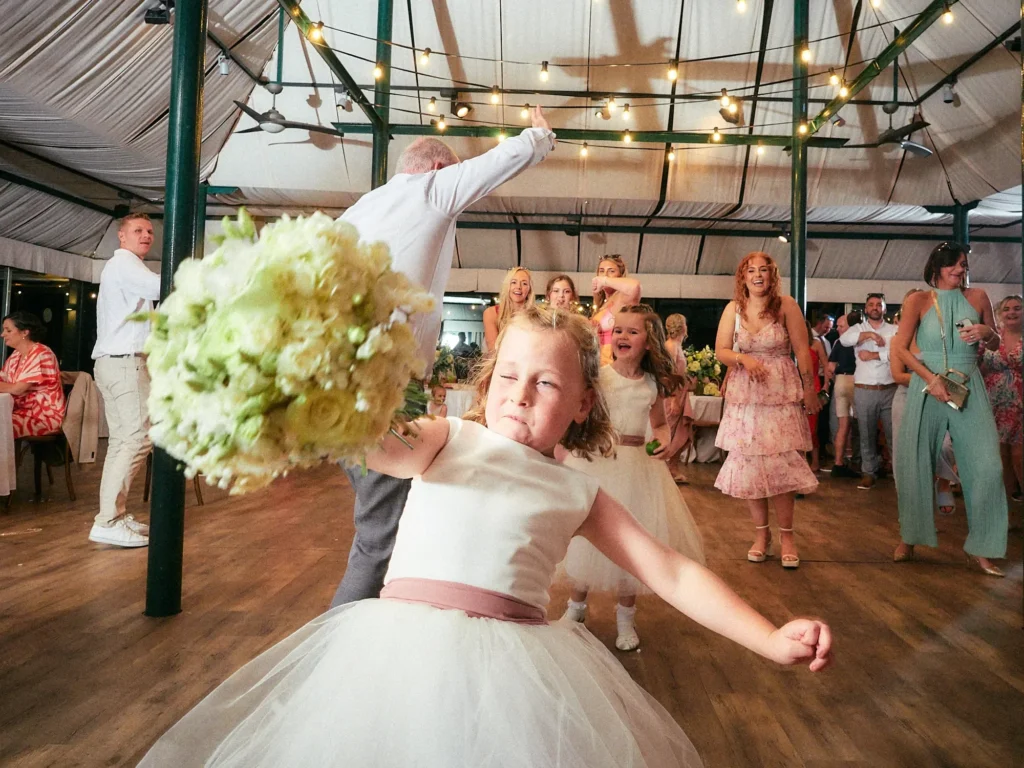 Young wedding guest dancing on the floor at Jade and Aidhan’s Hotel Miramar reception