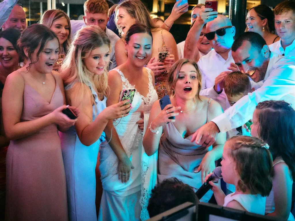 Wedding guests dancing together at Jade and Aidhan’s Hotel Miramar reception