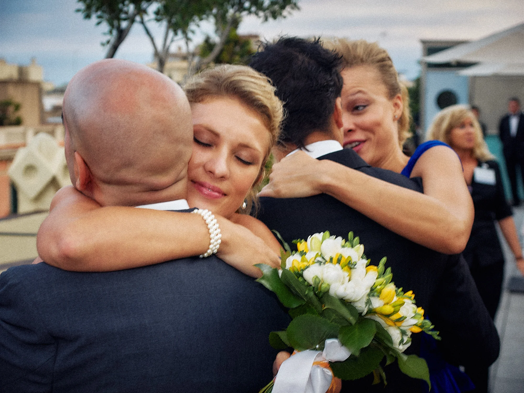 Jose and Kristy’s Barcelona Wedding – Wedding Embrace Bride hugging a wedding guest while holding her bouquet in Barcelona