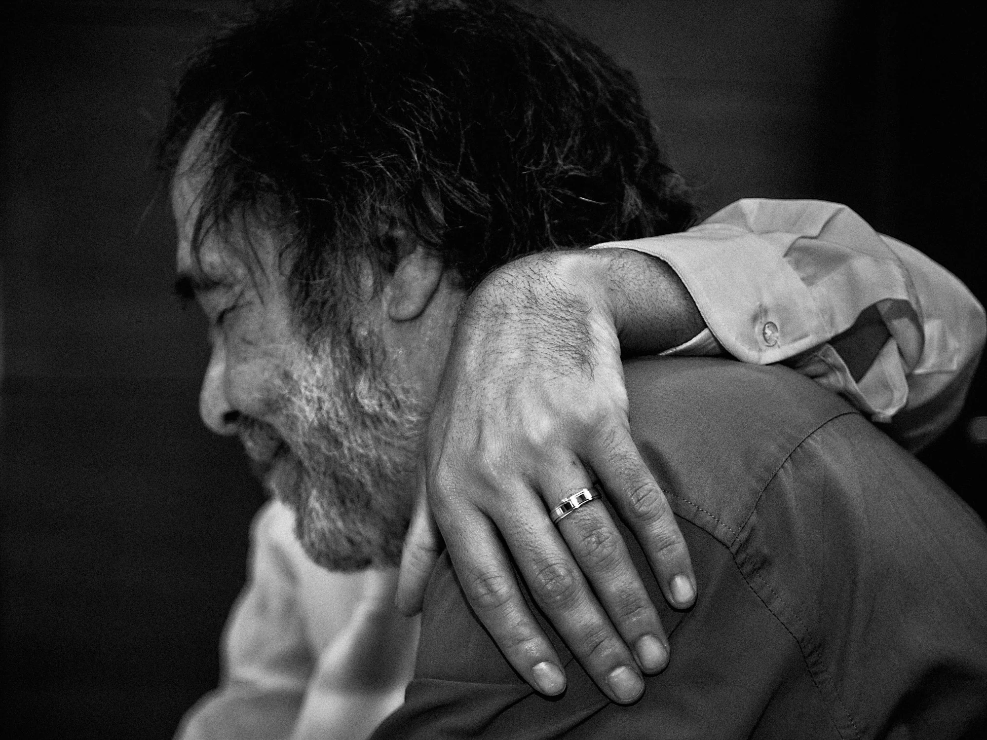 Jose and Kristy’s Barcelona Wedding – Emotional Embrace Wedding guest embracing a friend during the Barcelona reception