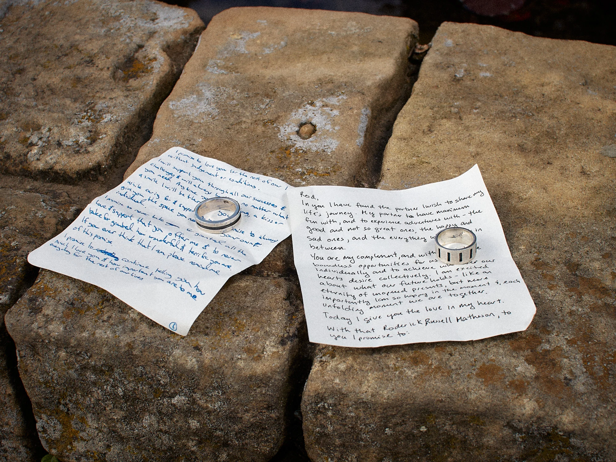 Handwritten vows and wedding rings on stone in Montjuïc